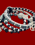 Set of black and silver beaded bracelets with pentacle charm on a red background